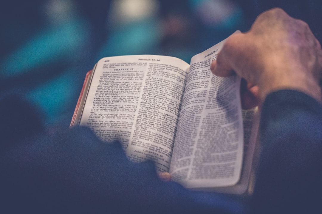 Person reading an open Bible